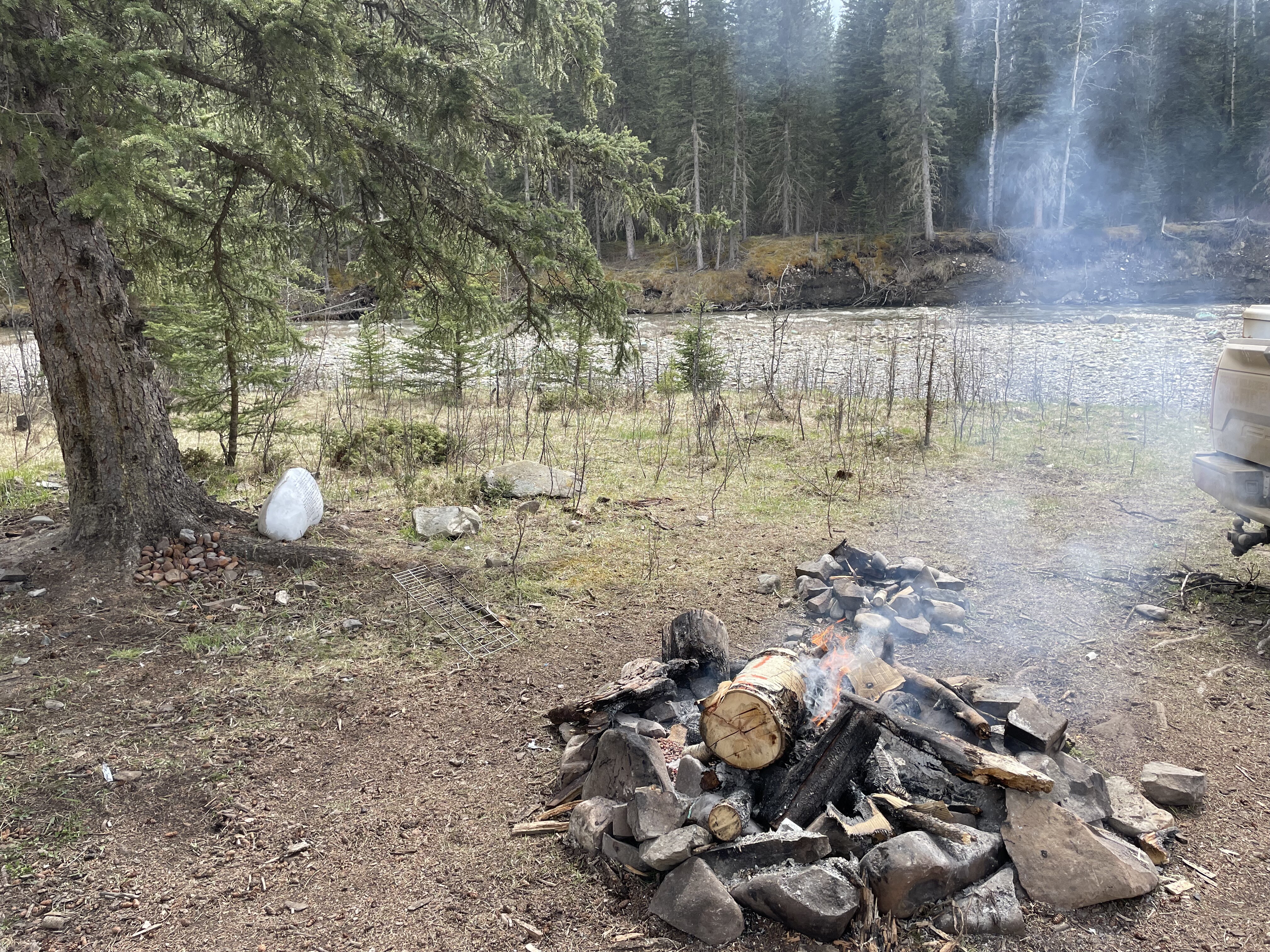 Abandoned campfire beside river